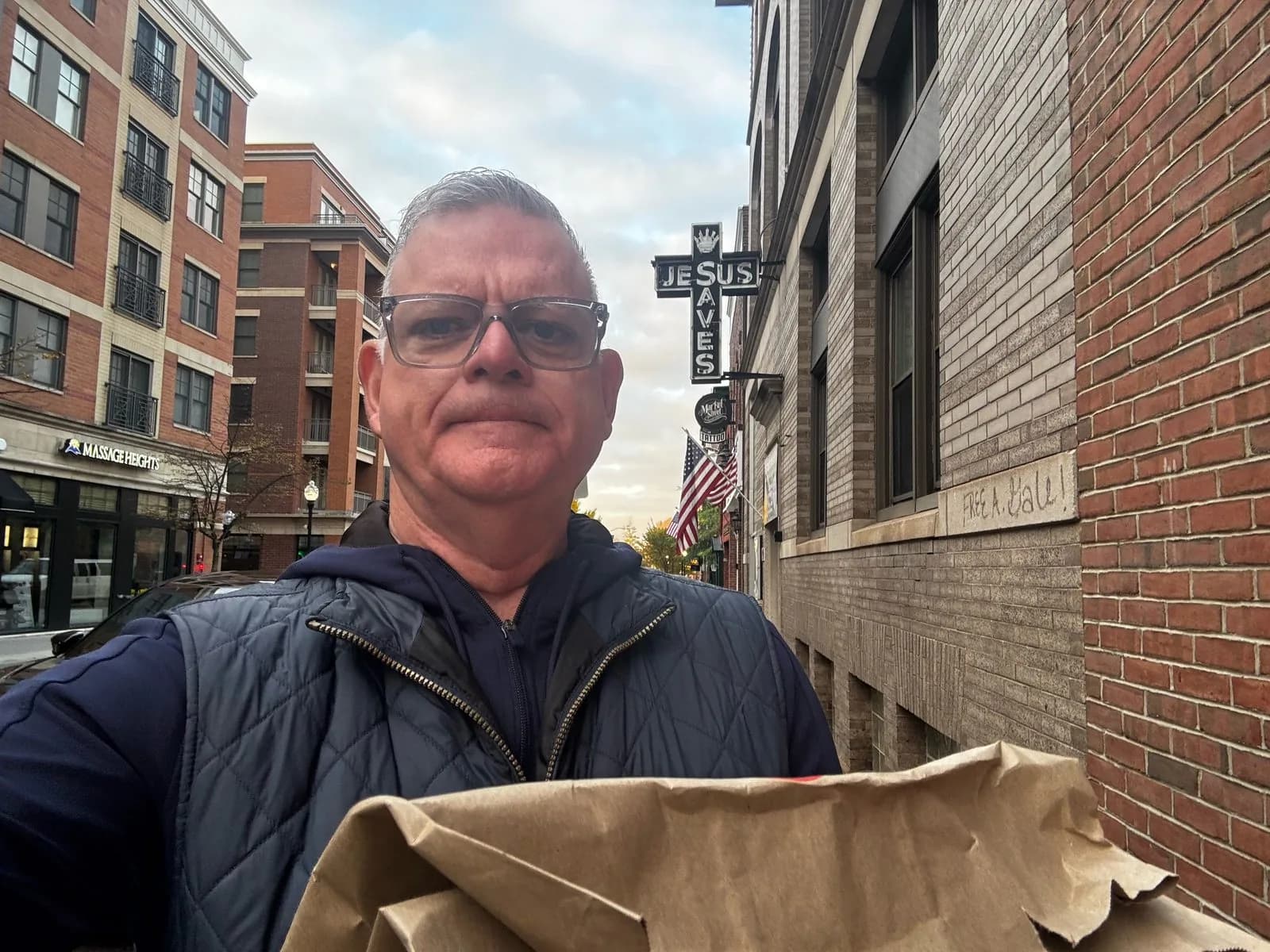 Sean outside Market Street Mission in Morristown holding a bag of leftover party food
